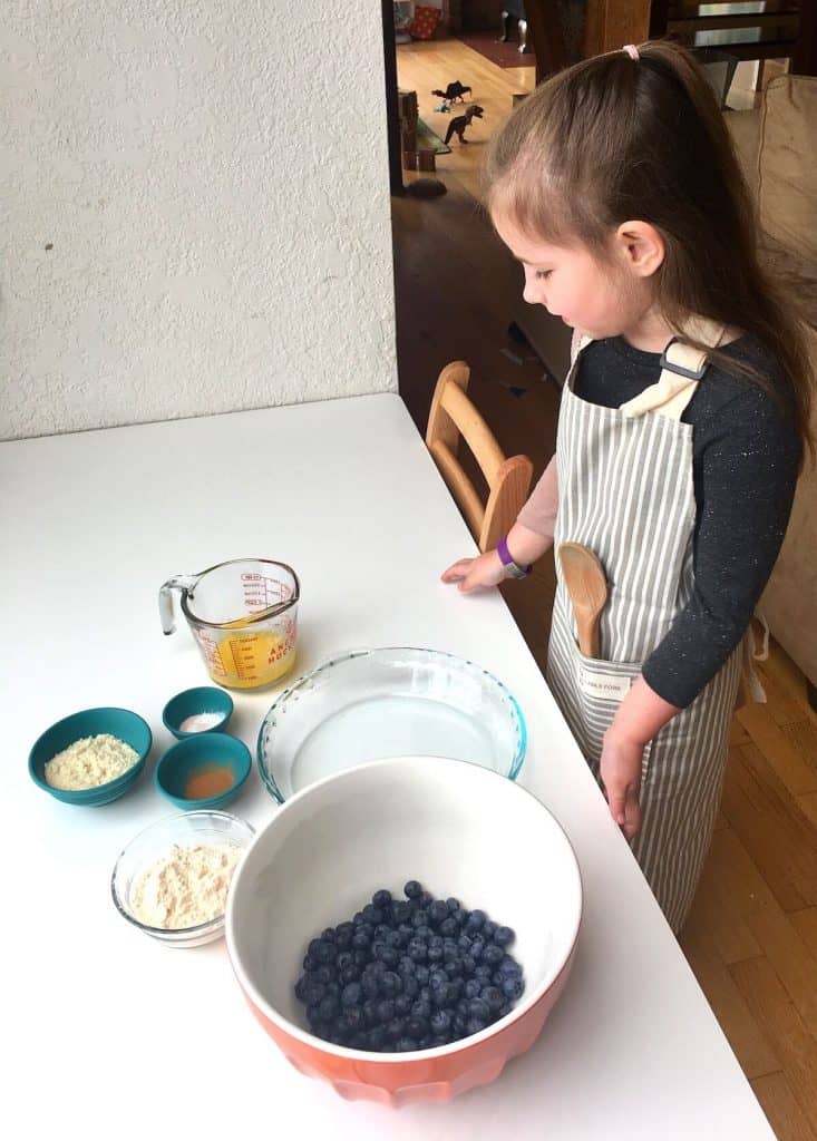 Montessori kitchen setup for baking blueberry cake with ingredients on table