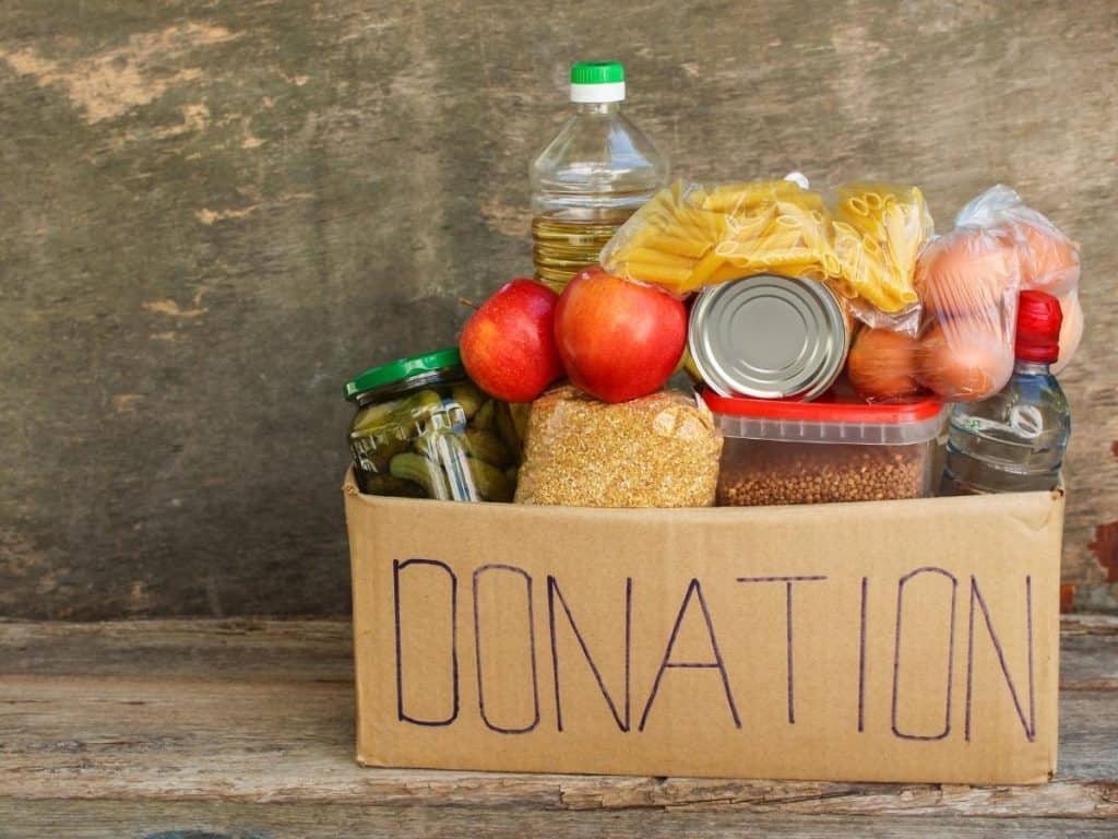 a donation box with perishable food items inside as a winter bucket list item