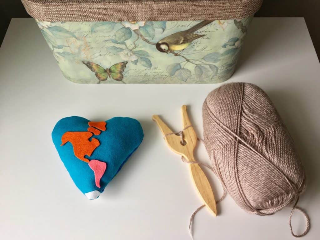 heart pillow and a lucet with yarn
