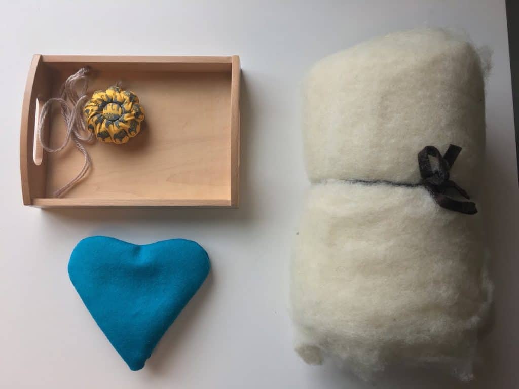 montessori tray with pincusion, heart pillow, and wool batting