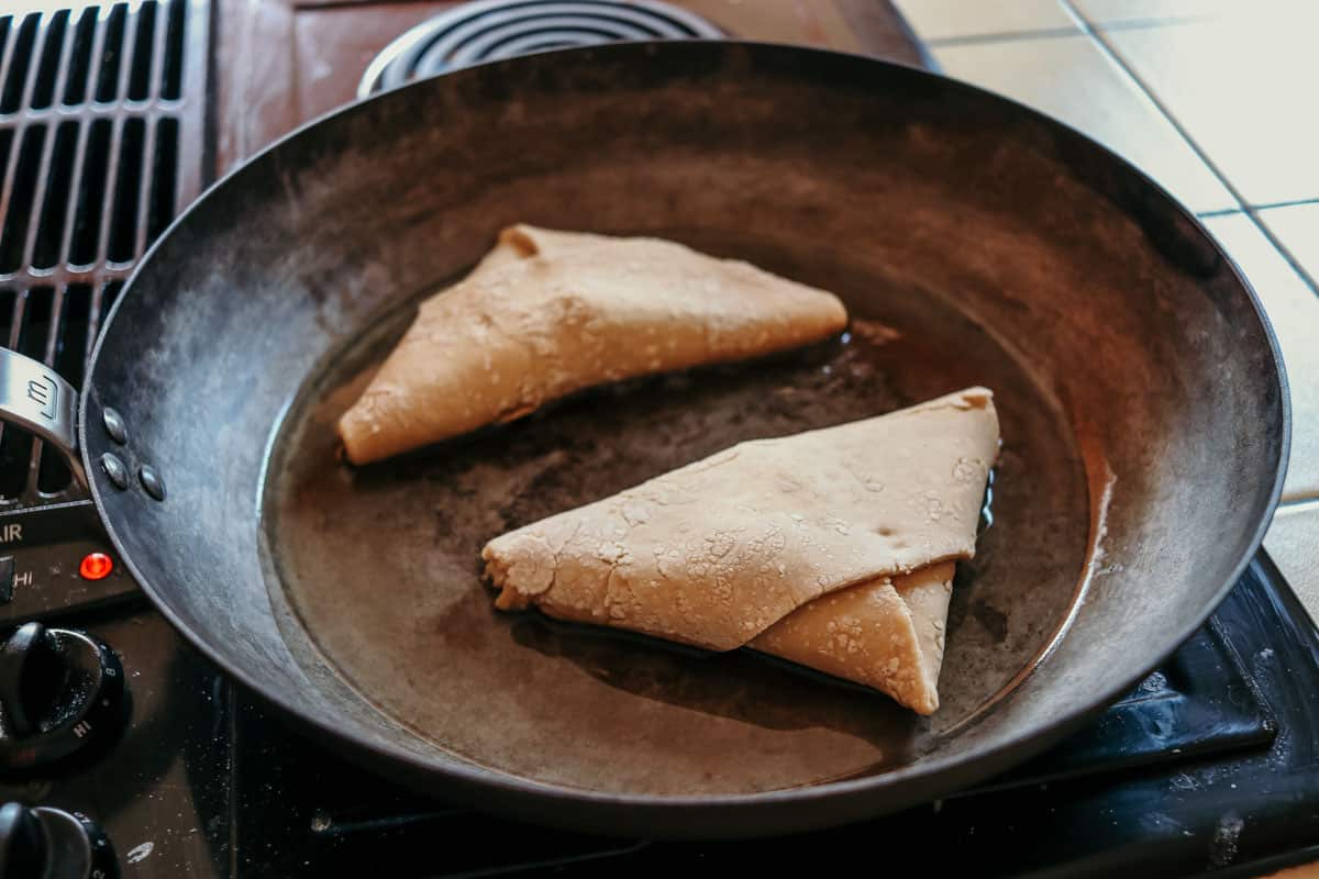 homemade Ethiopian sambusas frying in a pan