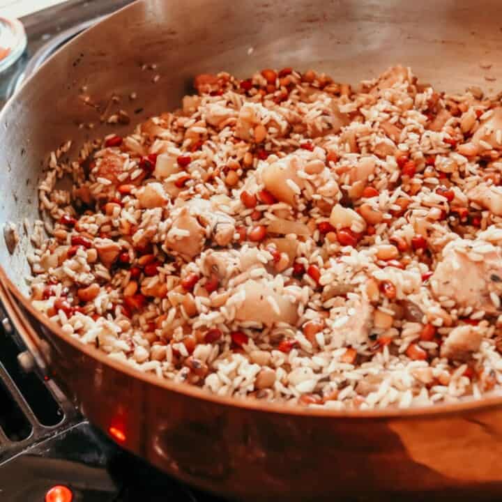 closeup of Hoppin' John cooking in a copper saucier