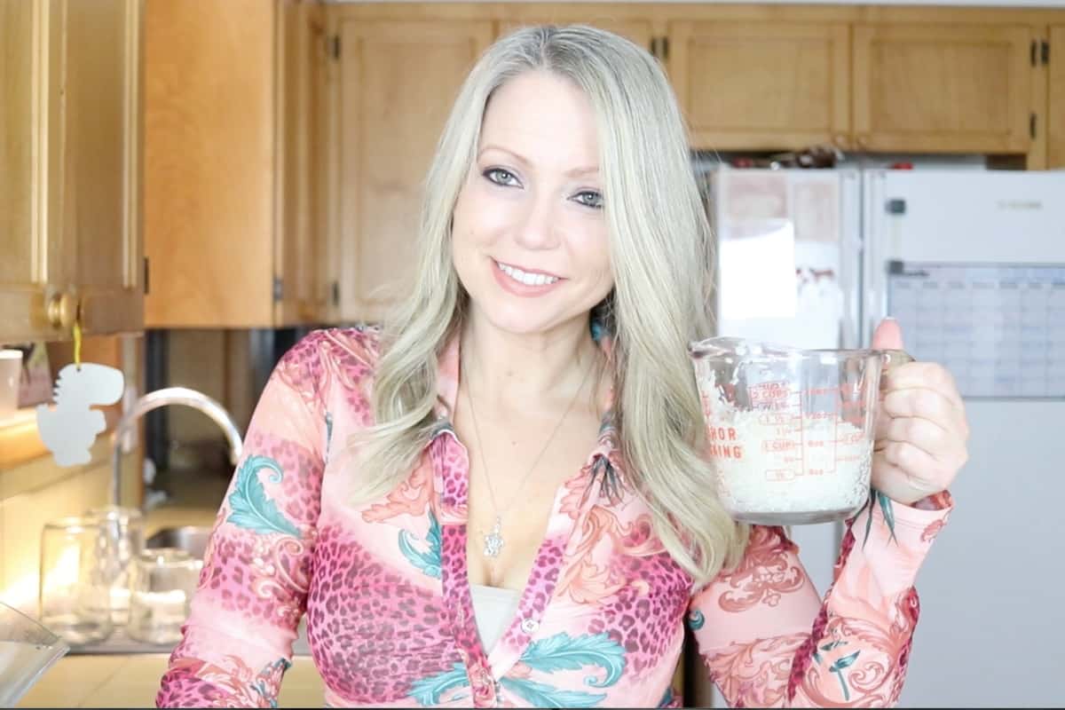 mom holding a measuring cup with rice in it