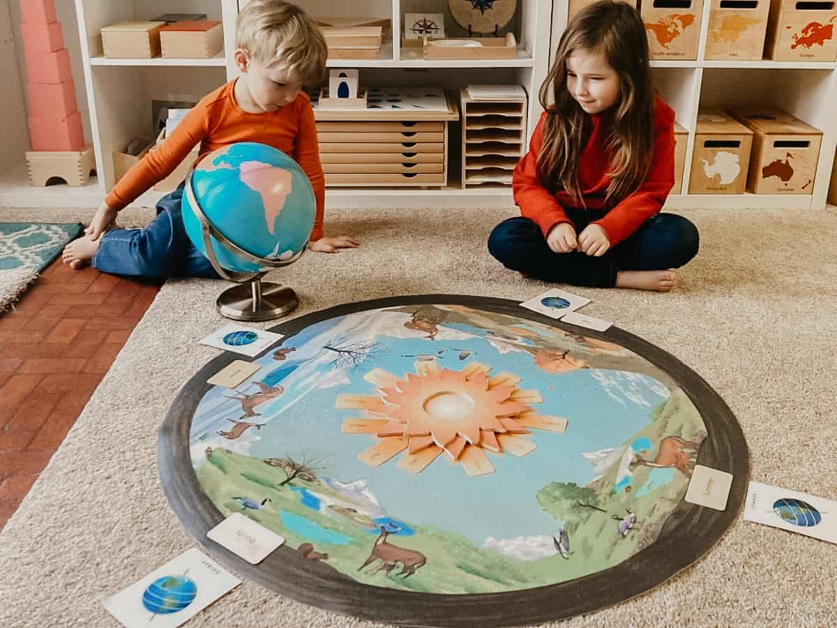 Montessori kids sitting around the Waseca Biomes Seasons Mat and Celebration Sun with a globe.