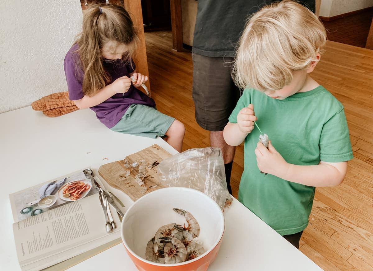 kids deveining prawns using floss picks