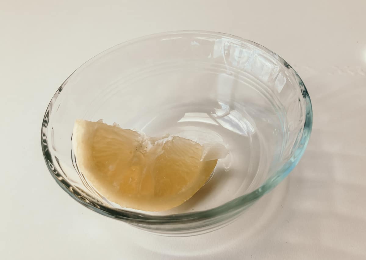 a lemon wedge in a bowl