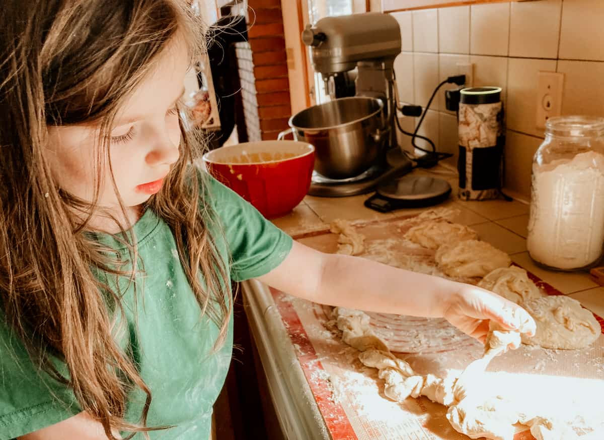 child twining bread dough to make Ukrainian bread