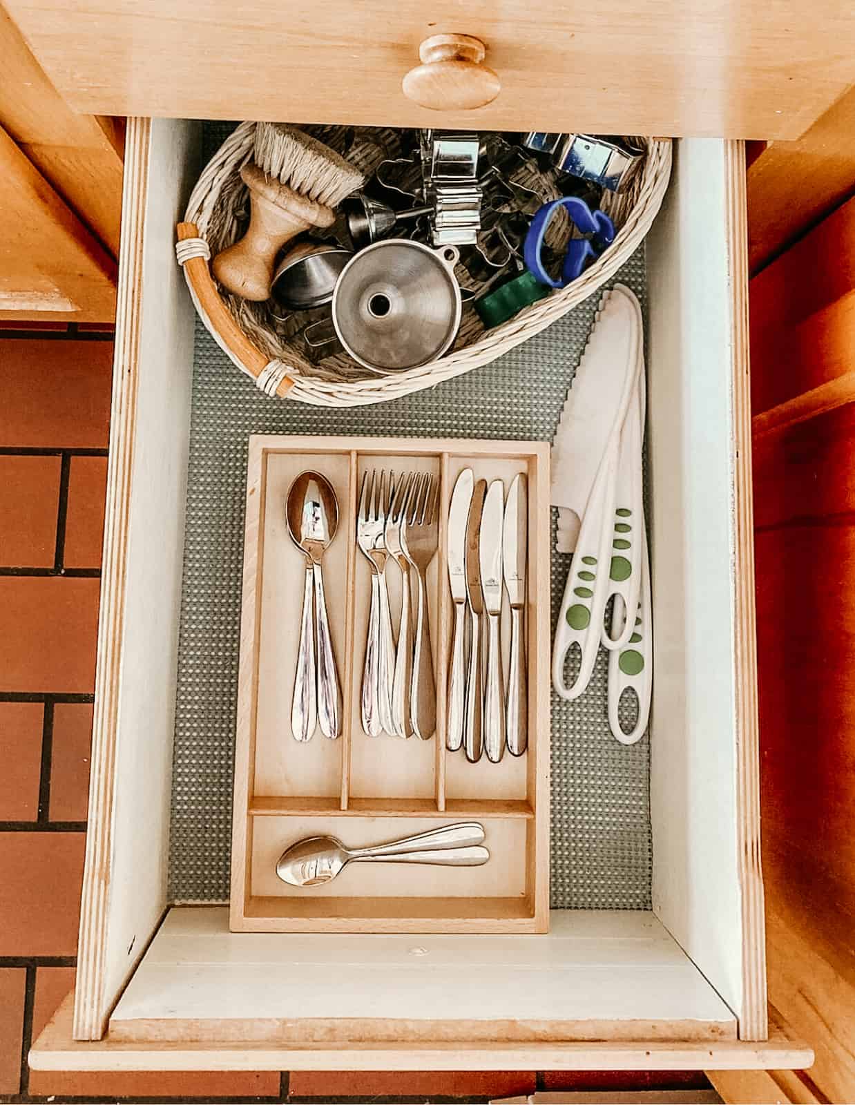 Kid's kitchen tools in drawer organizers for learning how to cook