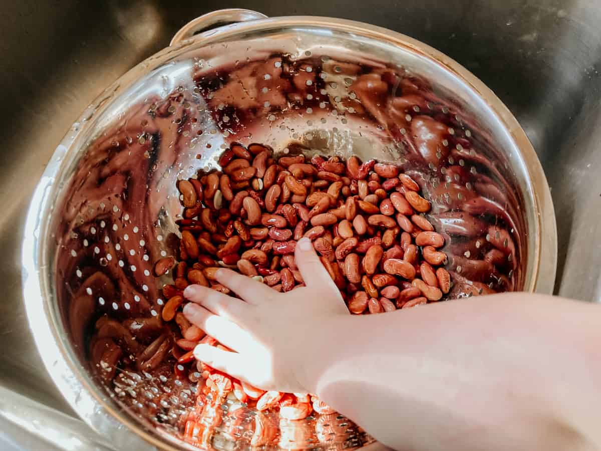 draining and rinsing kidney beans in a colander