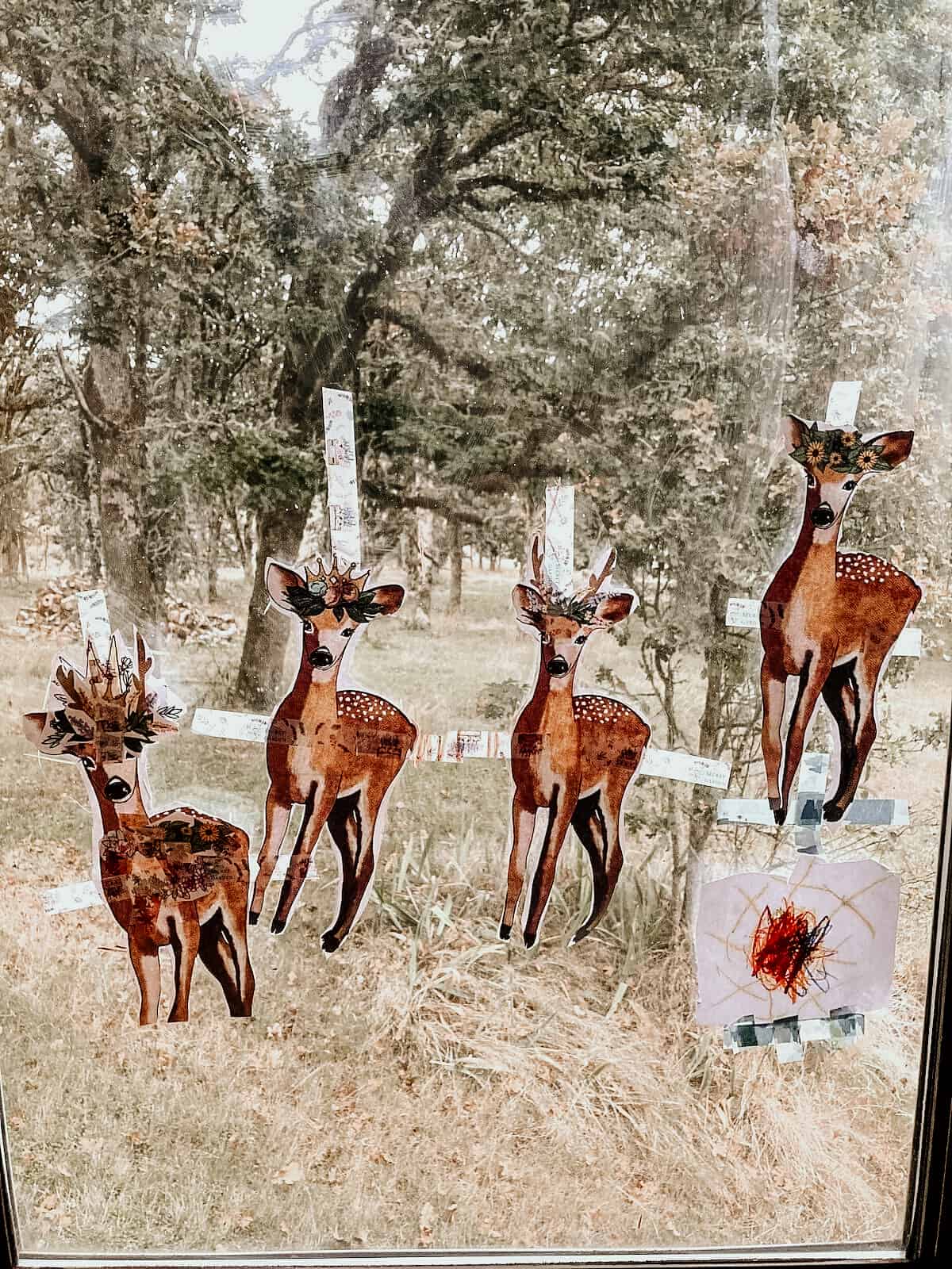 Pictures of Deer and a Sun Taped to a Window