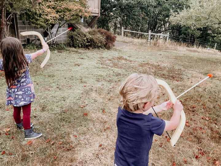 children using toy bow and arrows