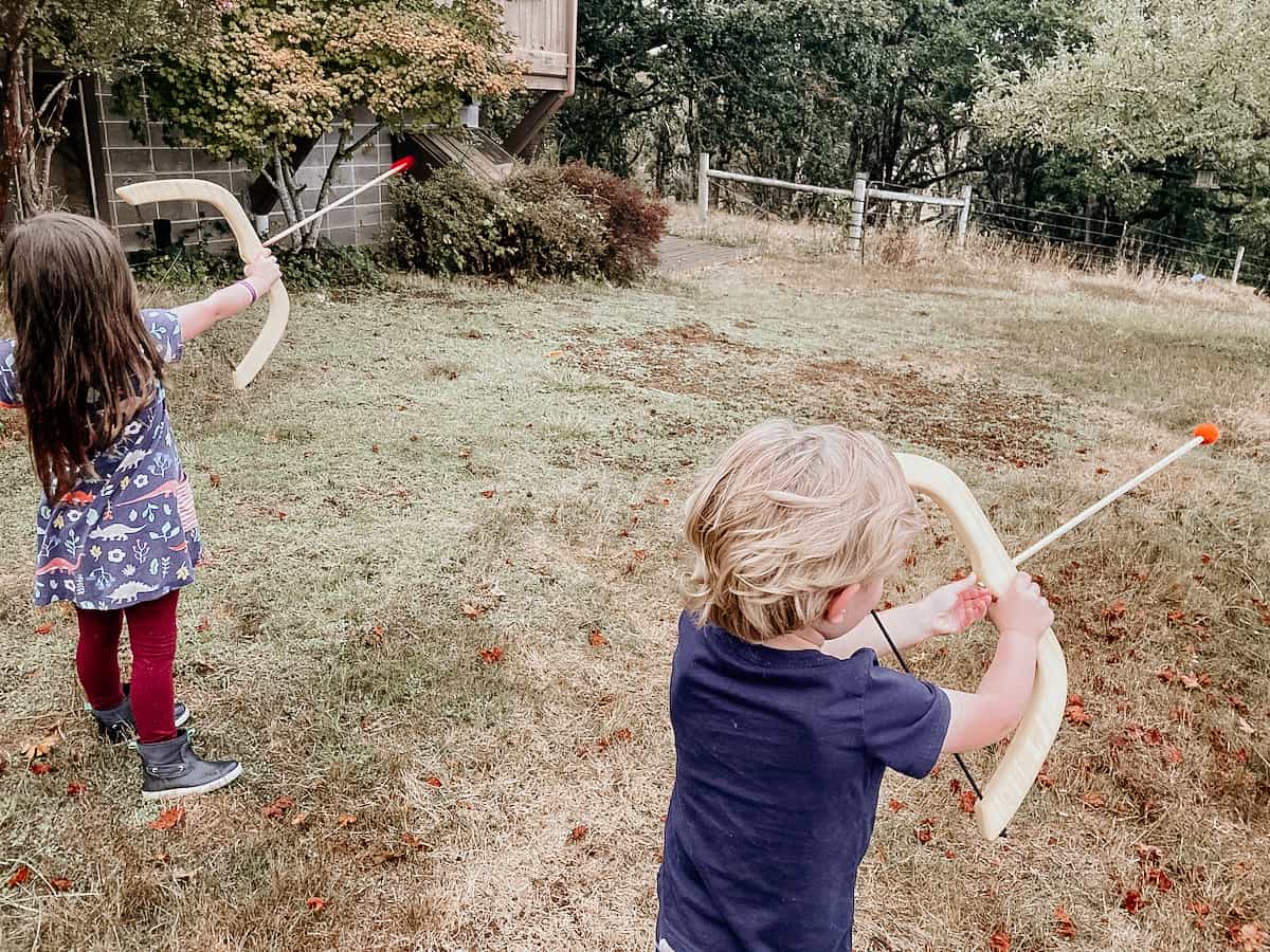 children using toy bow and arrows