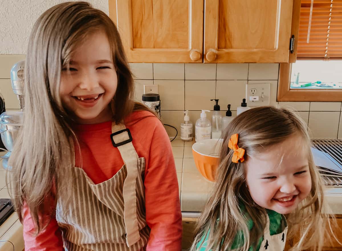 kids smiling and making funny faces in the kitchen