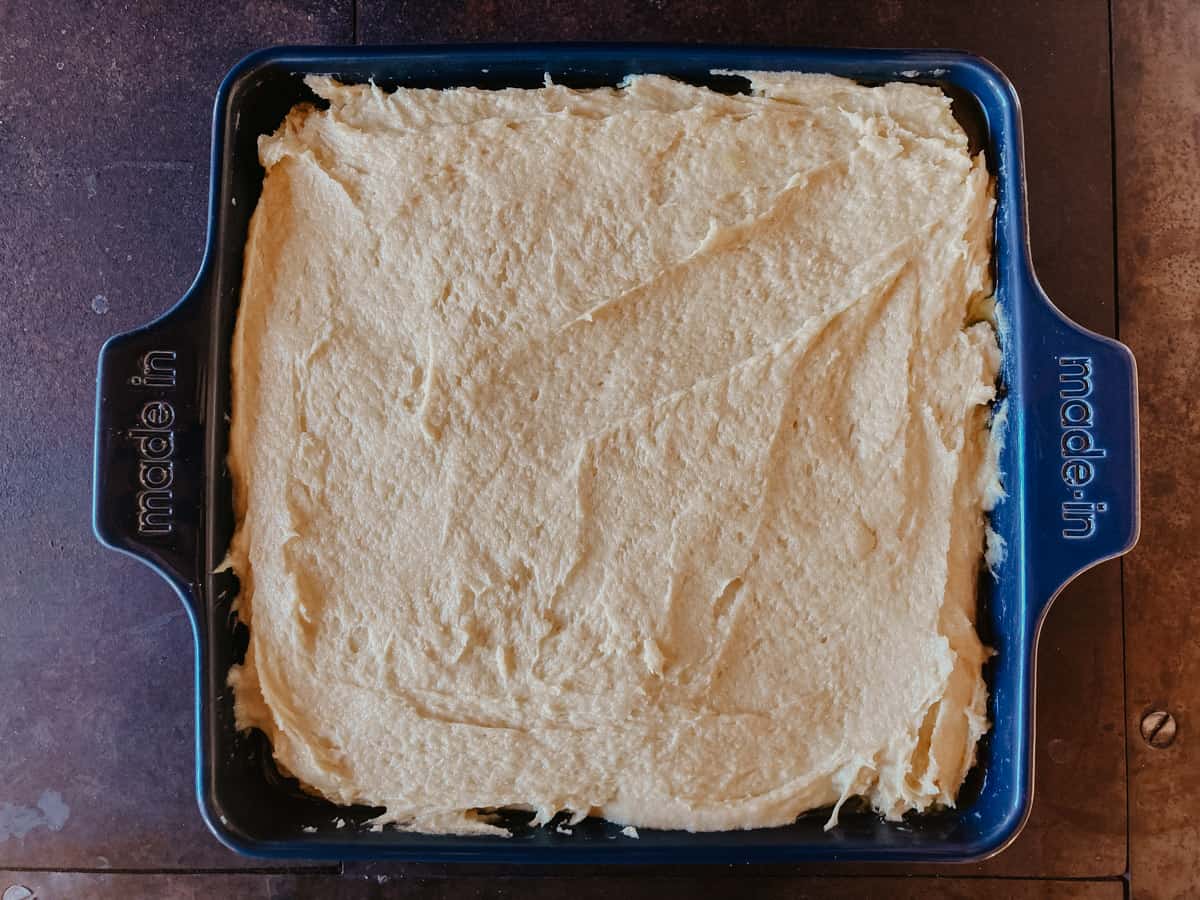 cinnamon pound cake batter in a square baking dish