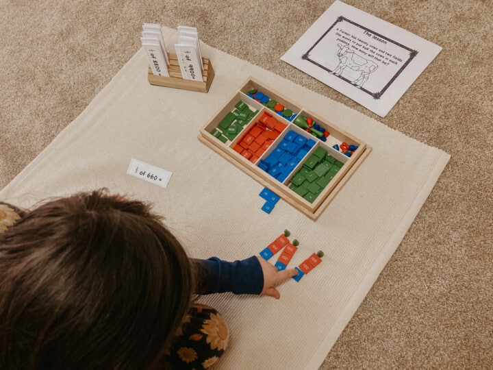 child working with the Montessori Stamp Game and the Montessorikiwi Fractions of an amount printable