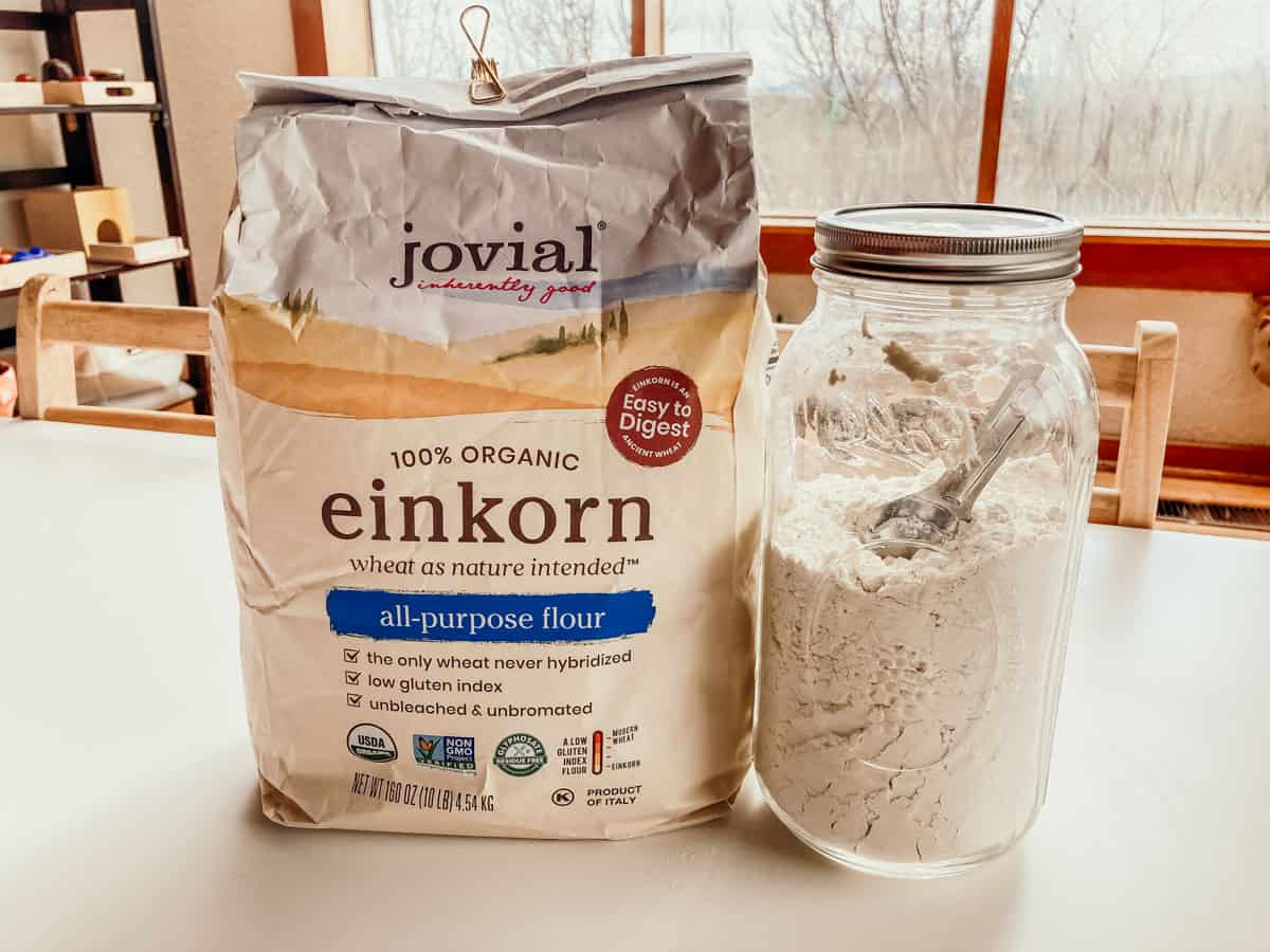 10 lb. bag of Jovial all-purpose einkorn flour on a kid's table next to a large jar of einkorn flour