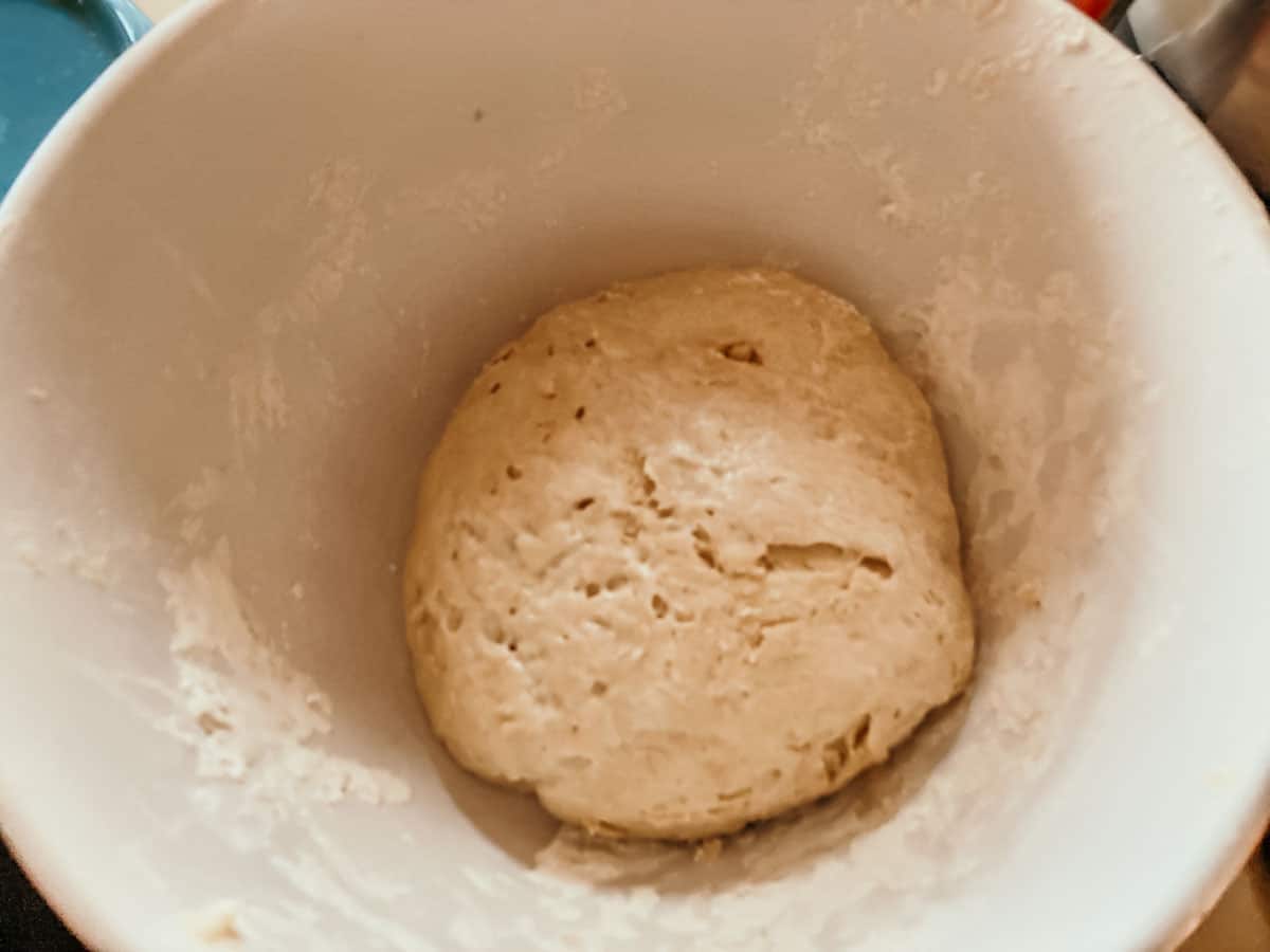rested dough for making stuffed crust pizza is sitting inside a large bowl