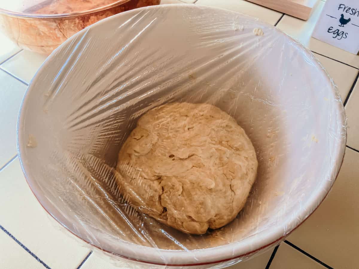 empanadilla dough in a bowl and covered with plastic wrap