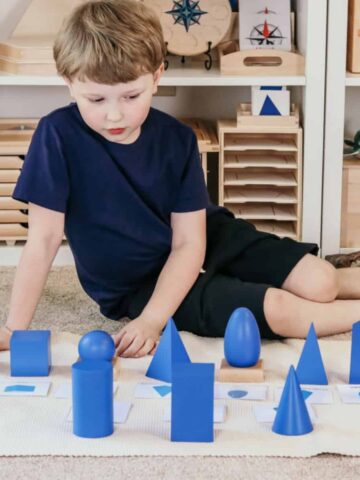 child working with the Montessori geometric solids in a homeschool room