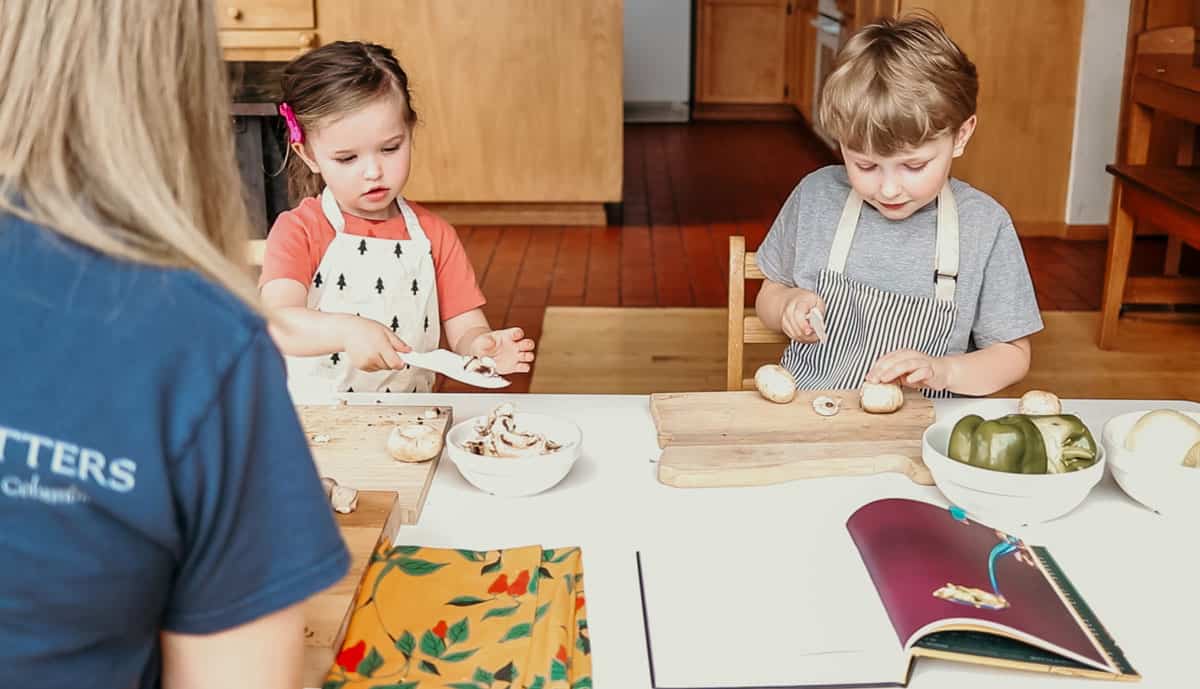 kids slicing cremini mushrooms with child-friendly knives and cutting boards