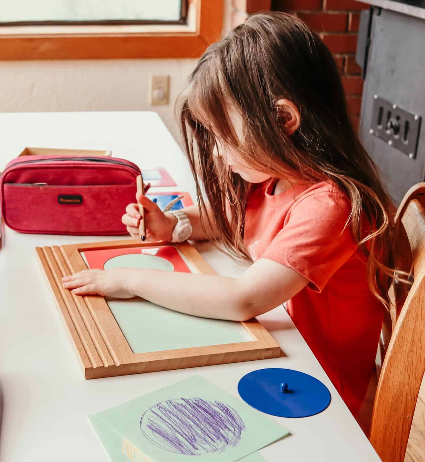 child working with Montessori metal insets