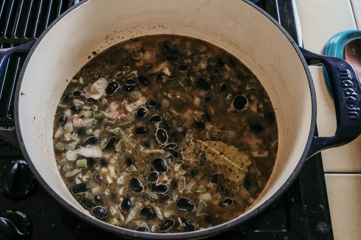 black beans and vegetables cooking in a Dutch oven