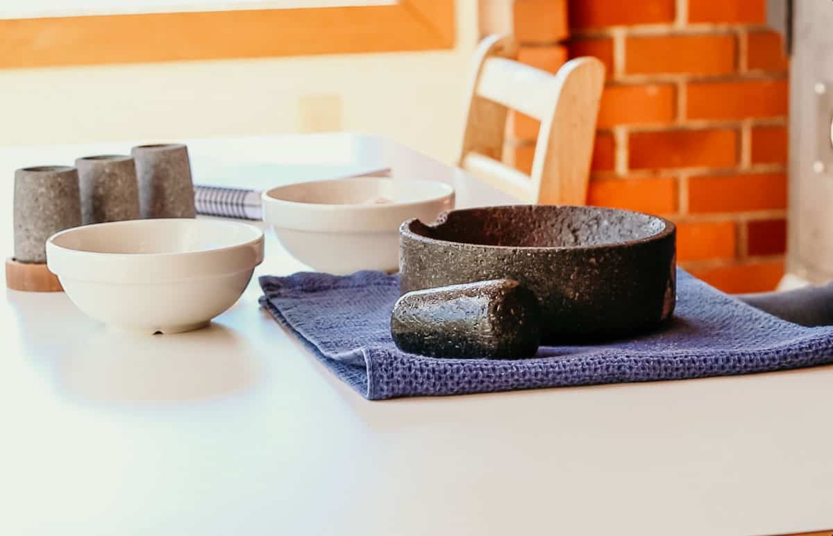 a wet molcajete resting on a towel on a kid's table