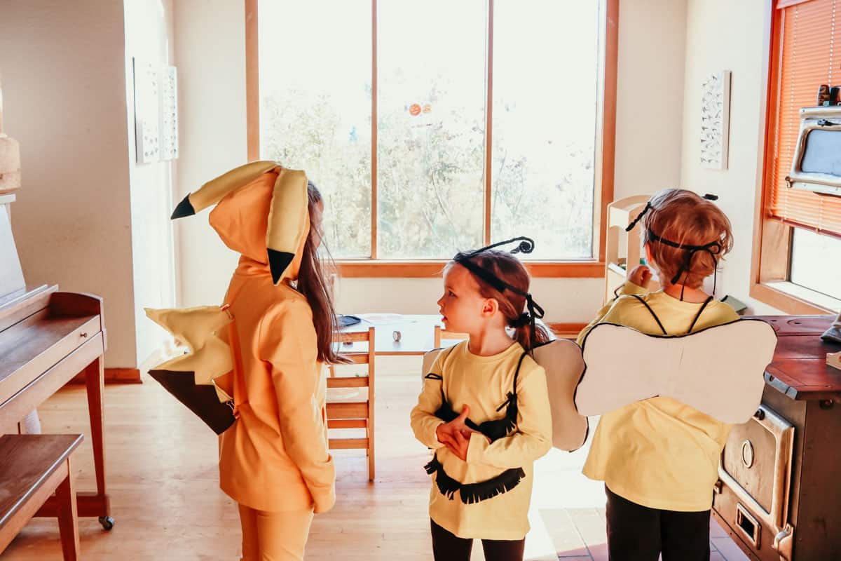 3 kids in homemade Halloween costumes: 1 Pikachu and 2 bees