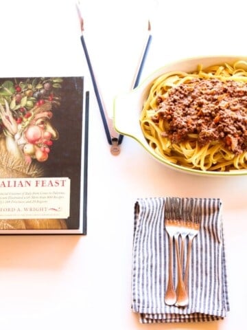 bison bolognese in a baking dish beside An Italian Feast cookbook