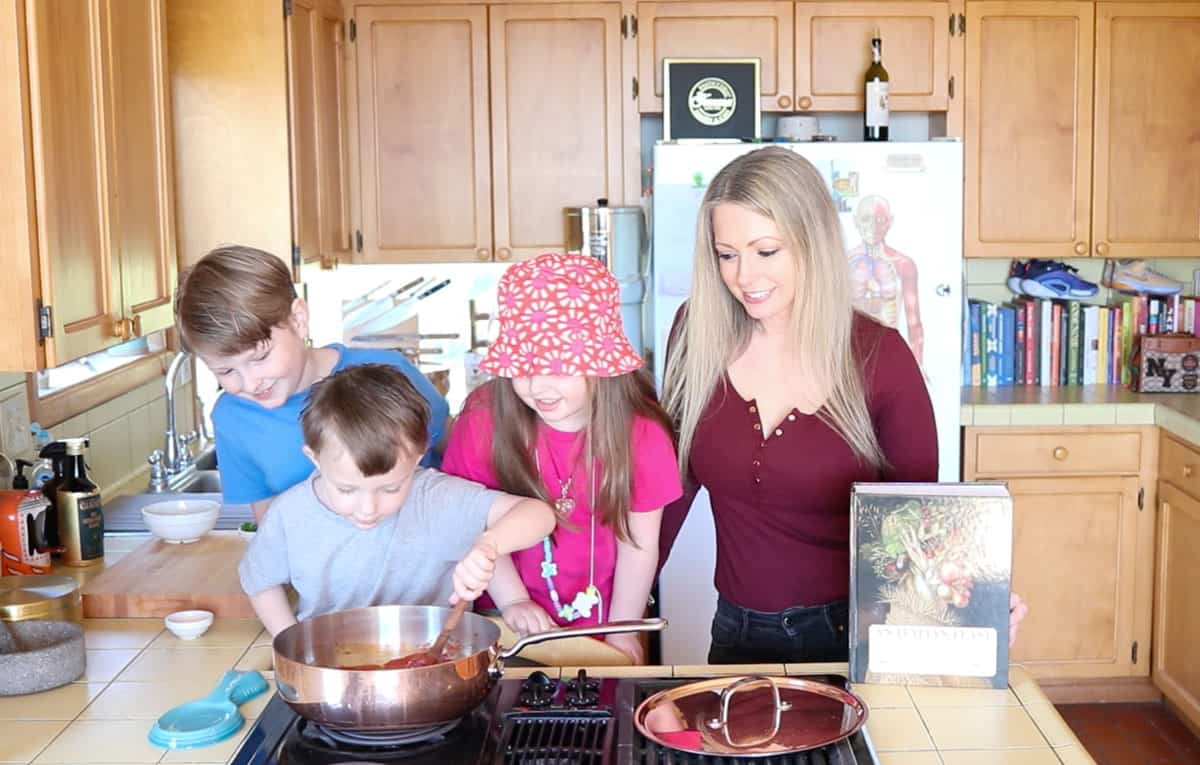 John is stirring the sauce while everyone watches