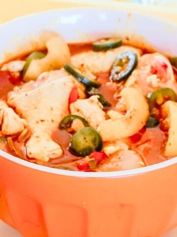 chicken drumsticks in a bowl of barbecue marinade