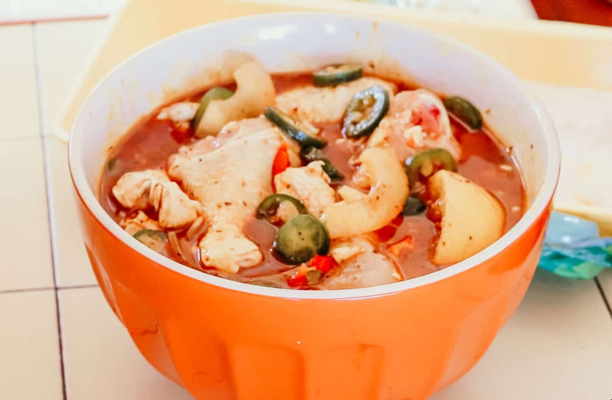 chicken drumsticks in a bowl of barbecue marinade