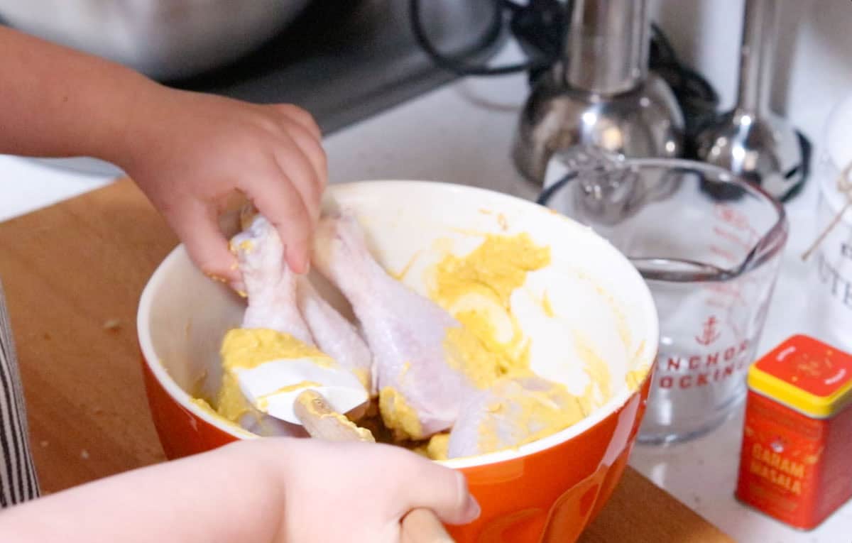 coating chicken drumsticks in yogurt-based marinade
