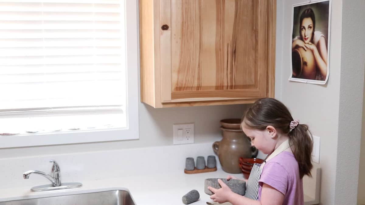 Katalina is holding a molcajete with ground spices