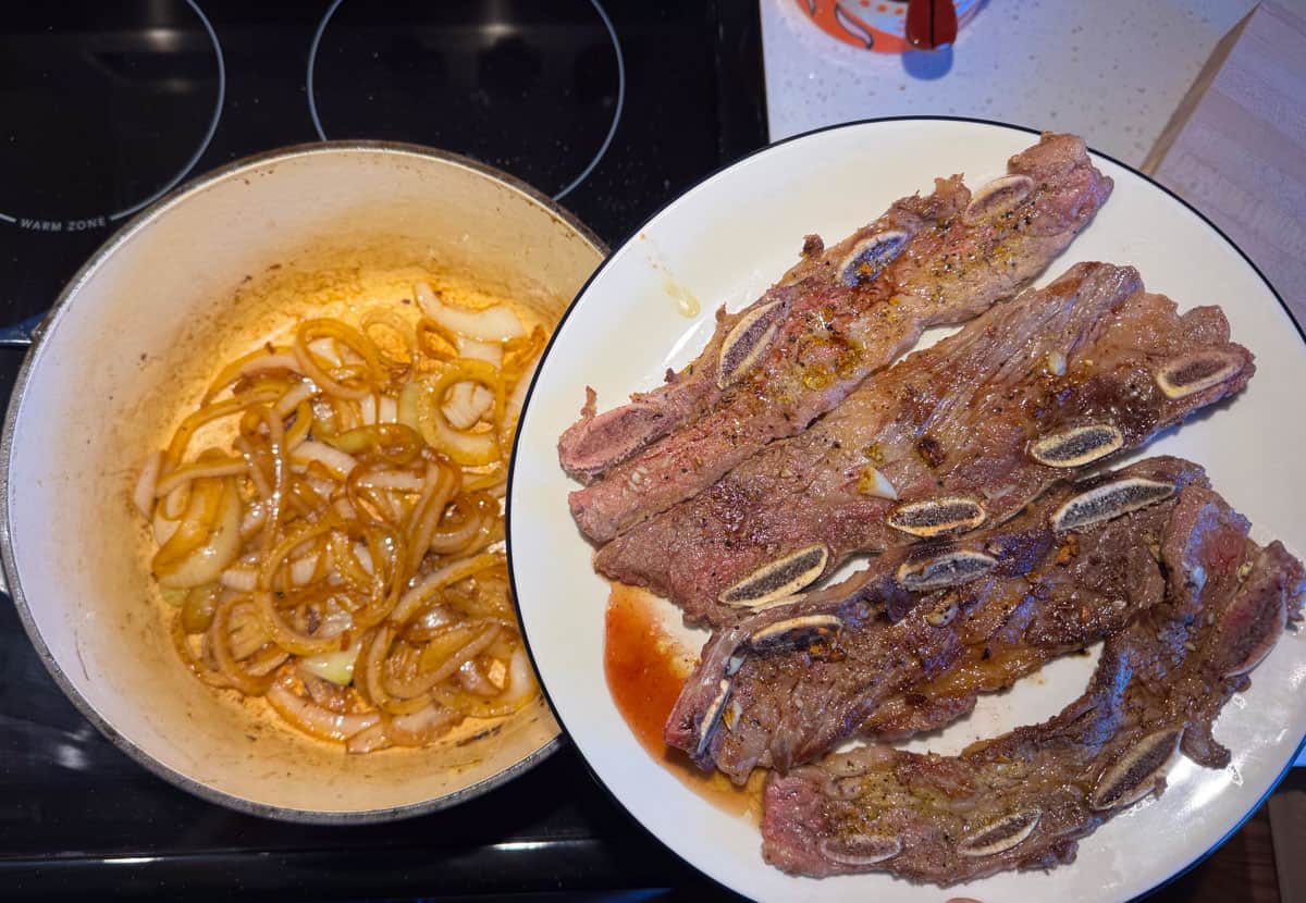 adding brisket back to the Dutch oven with the onions