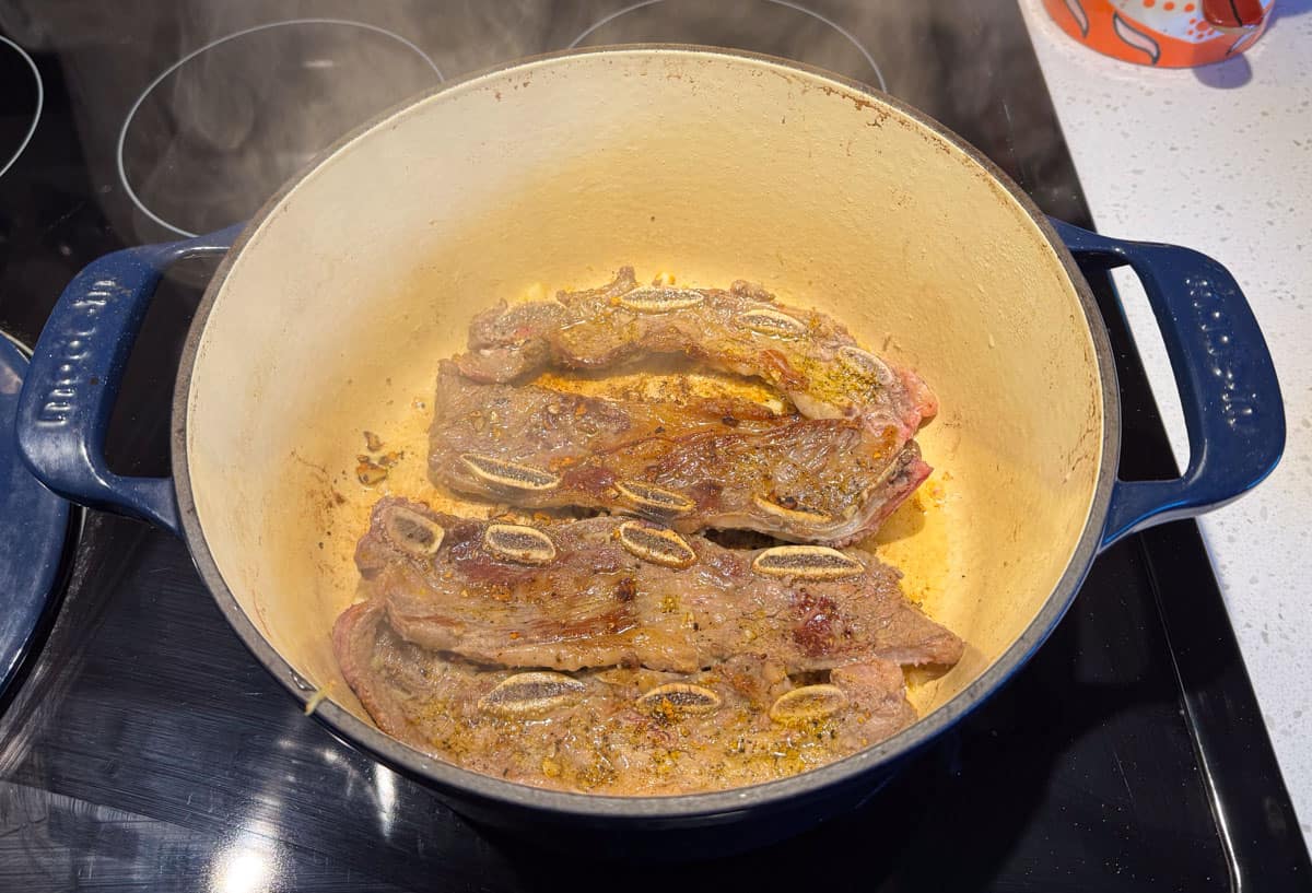 browning the brisket in the Dutch oven