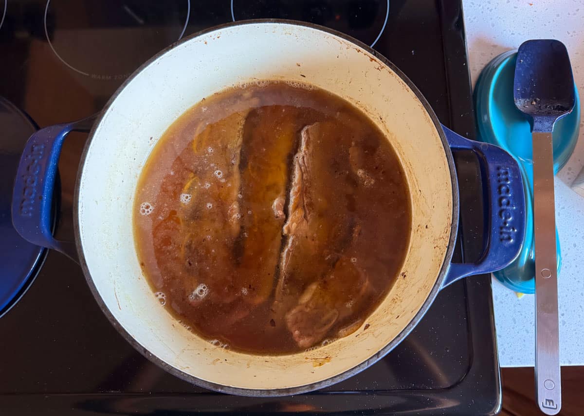 brisket, onions, and water in a Dutch oven