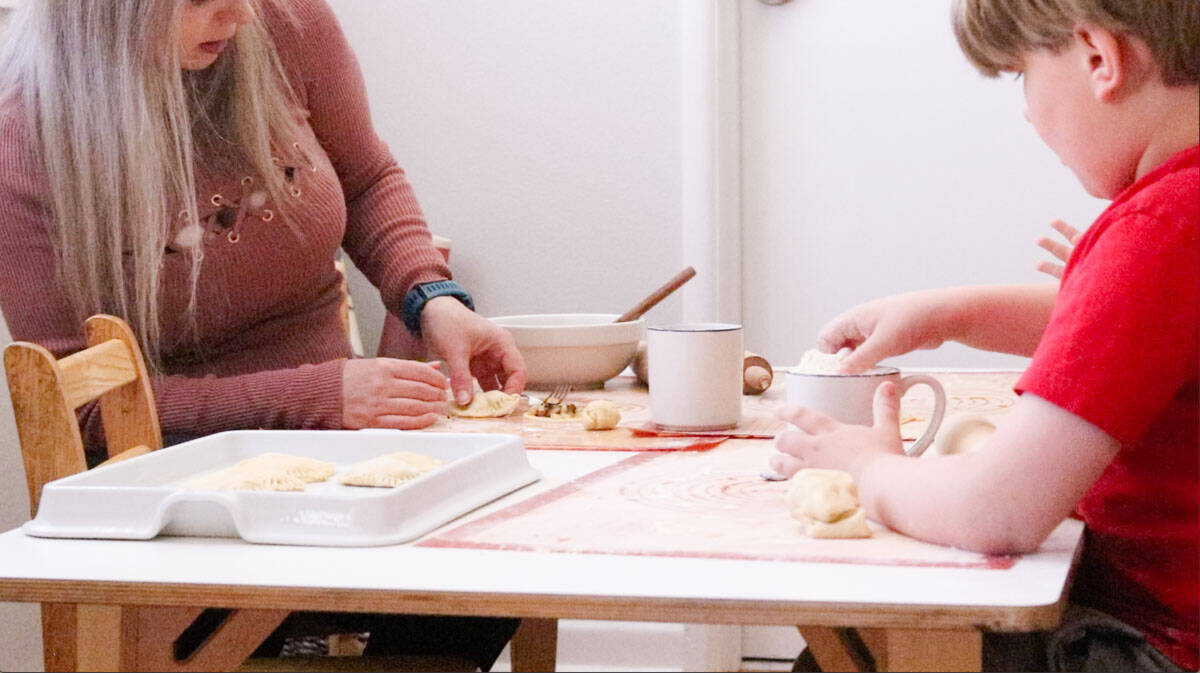 Noah is removing his dumpling dough from his mug
