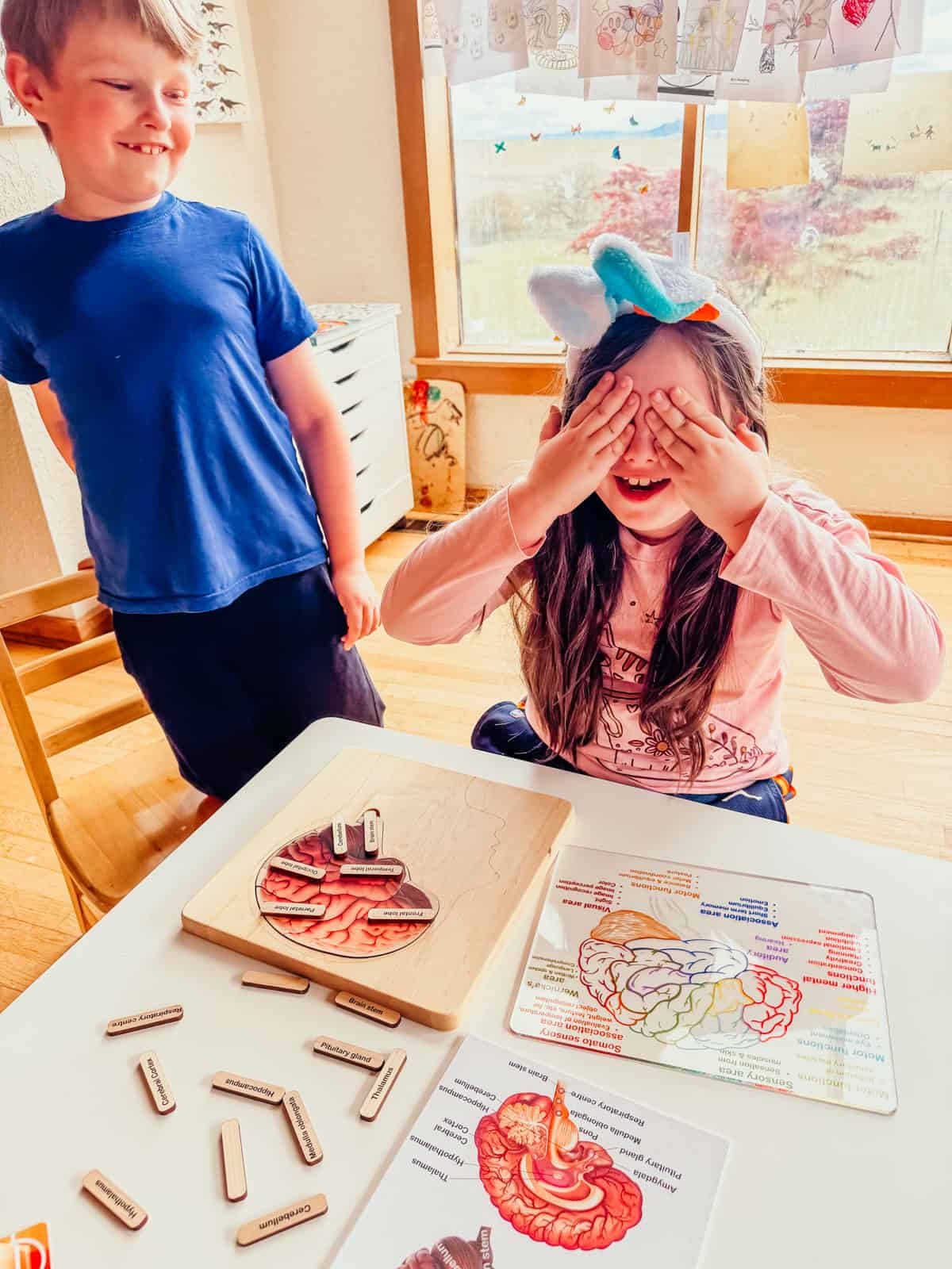 Kaia is covering her eyes to learn about parts of the brain