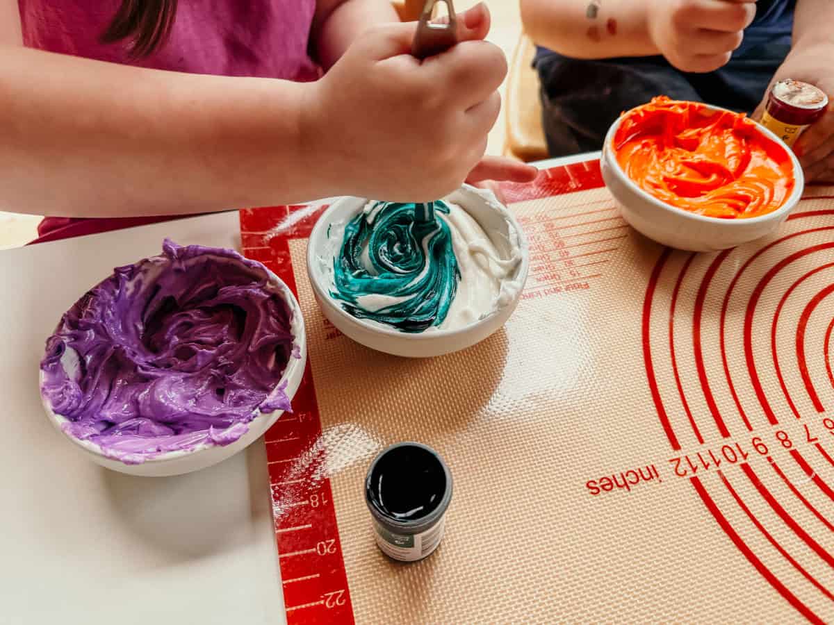Katalina and Noah are mixing food coloring into their Mexican sugar skulls