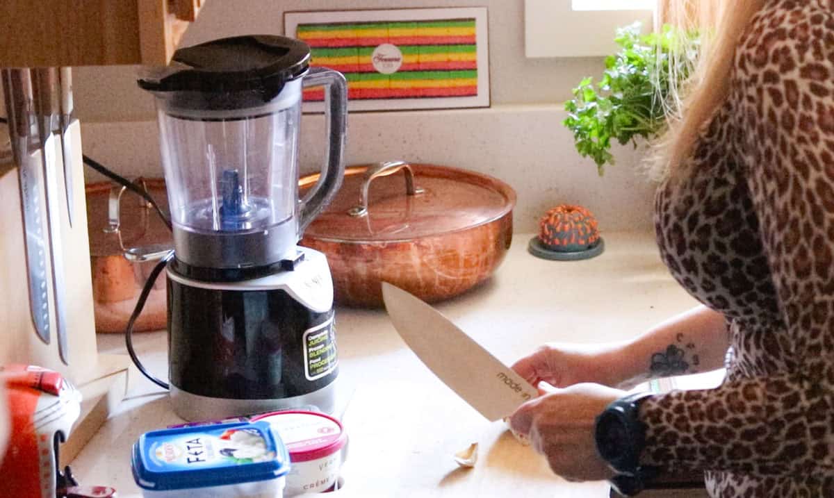 using a chefs knife to smash and peel garlic