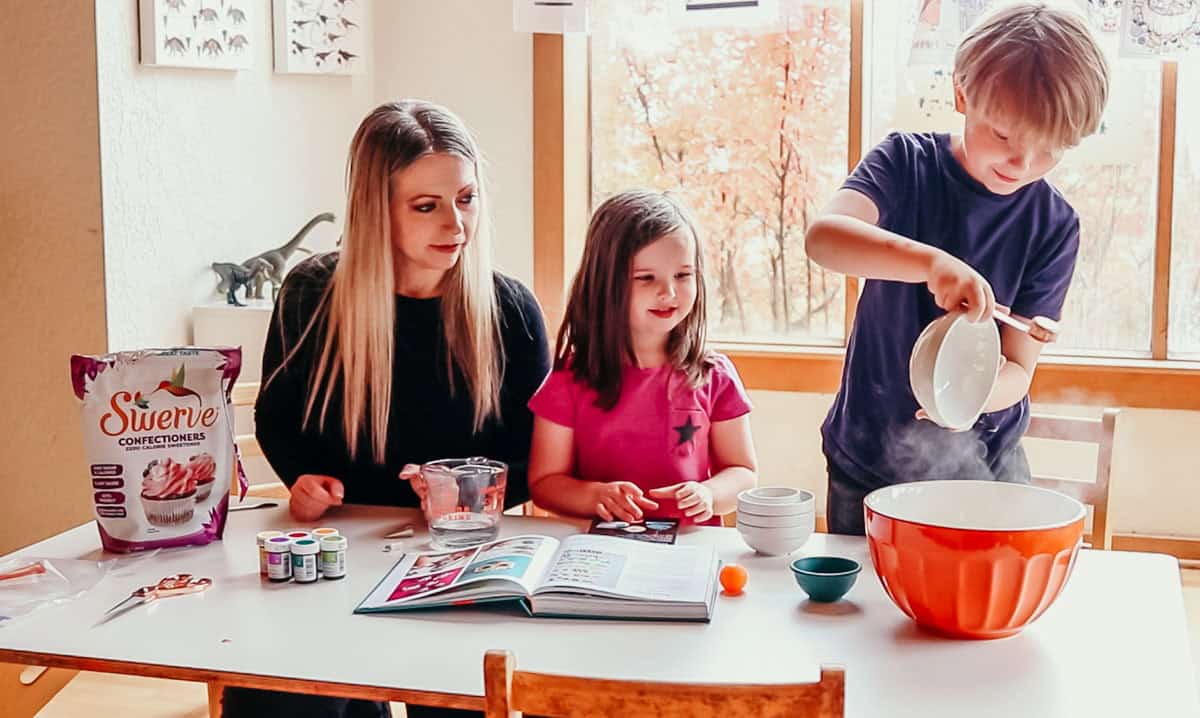 Noah is adding ingredients to a bowl for Mexican sugar skulls