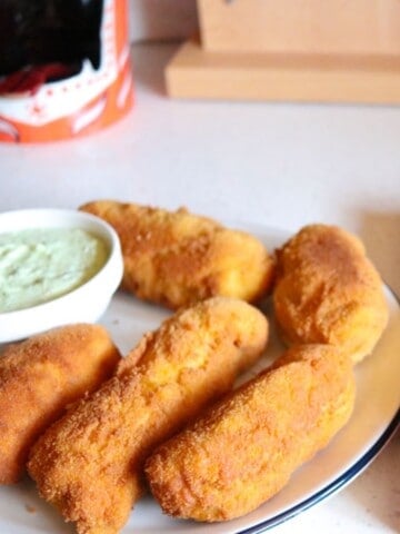 piroshki on a plate with feta sauce
