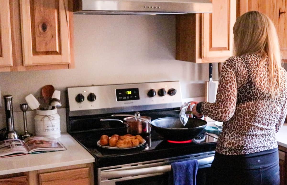 Kristin is transferring piroshki to a plate