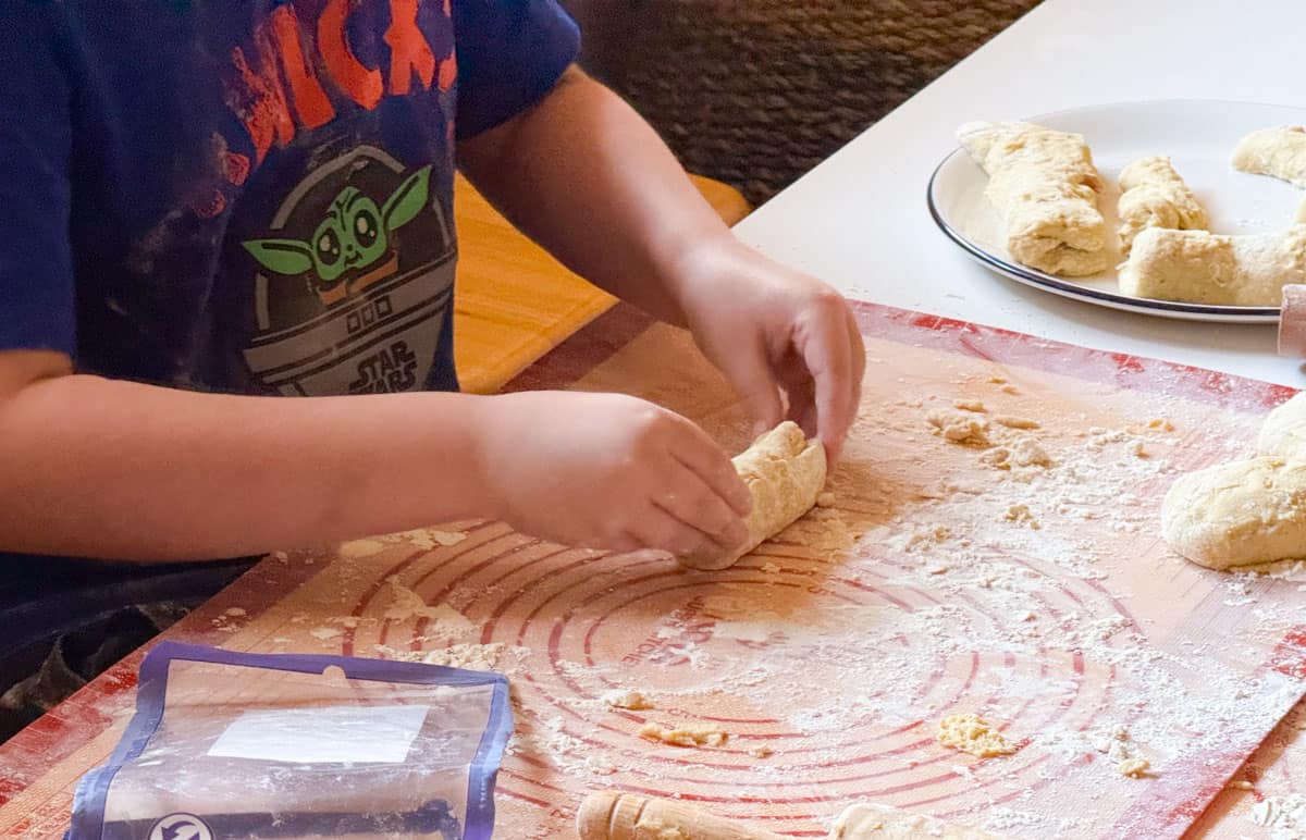 Noah is rolling up piroshki