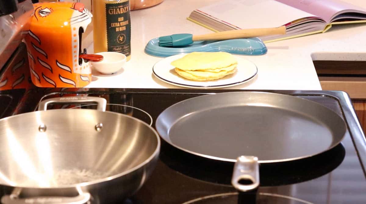 uncooked parathas on a plate beside a tawa