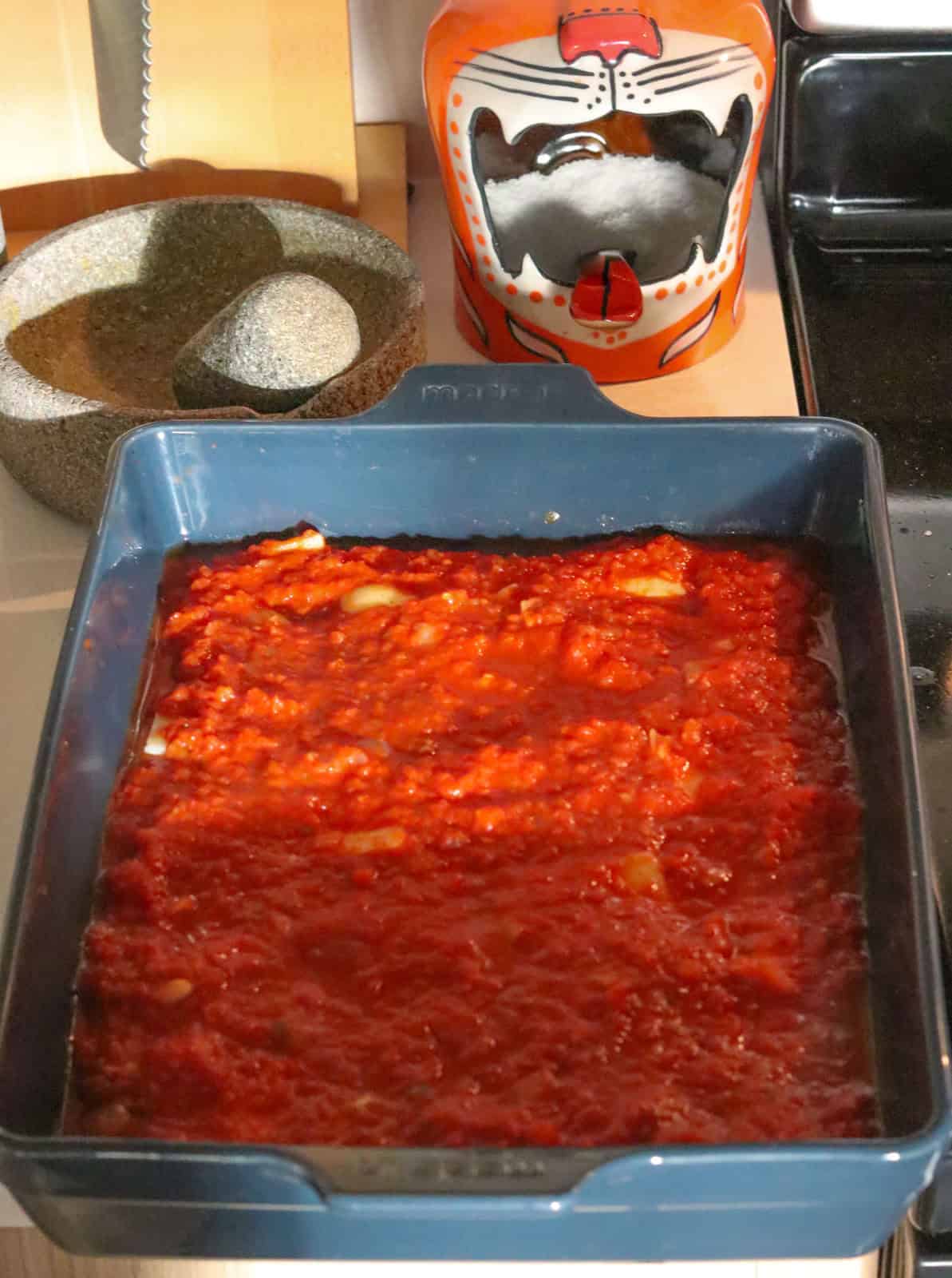 eggplant parmesan, unbaked, with sauce on top