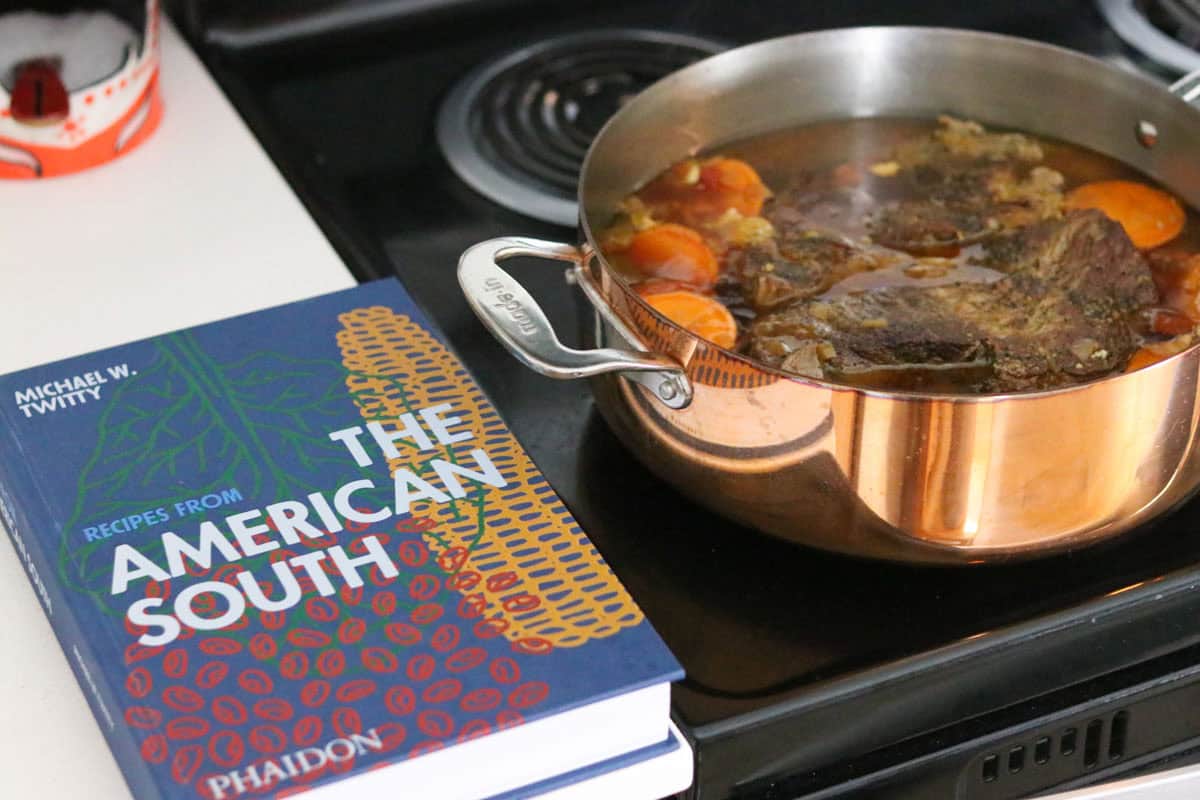 Recipes from The American South beside Gullah-Geechee Pot Roast on the stove
