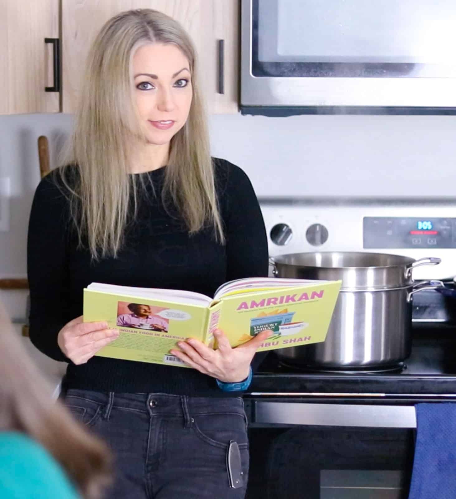 Kristin is holding Amrikan cookbook