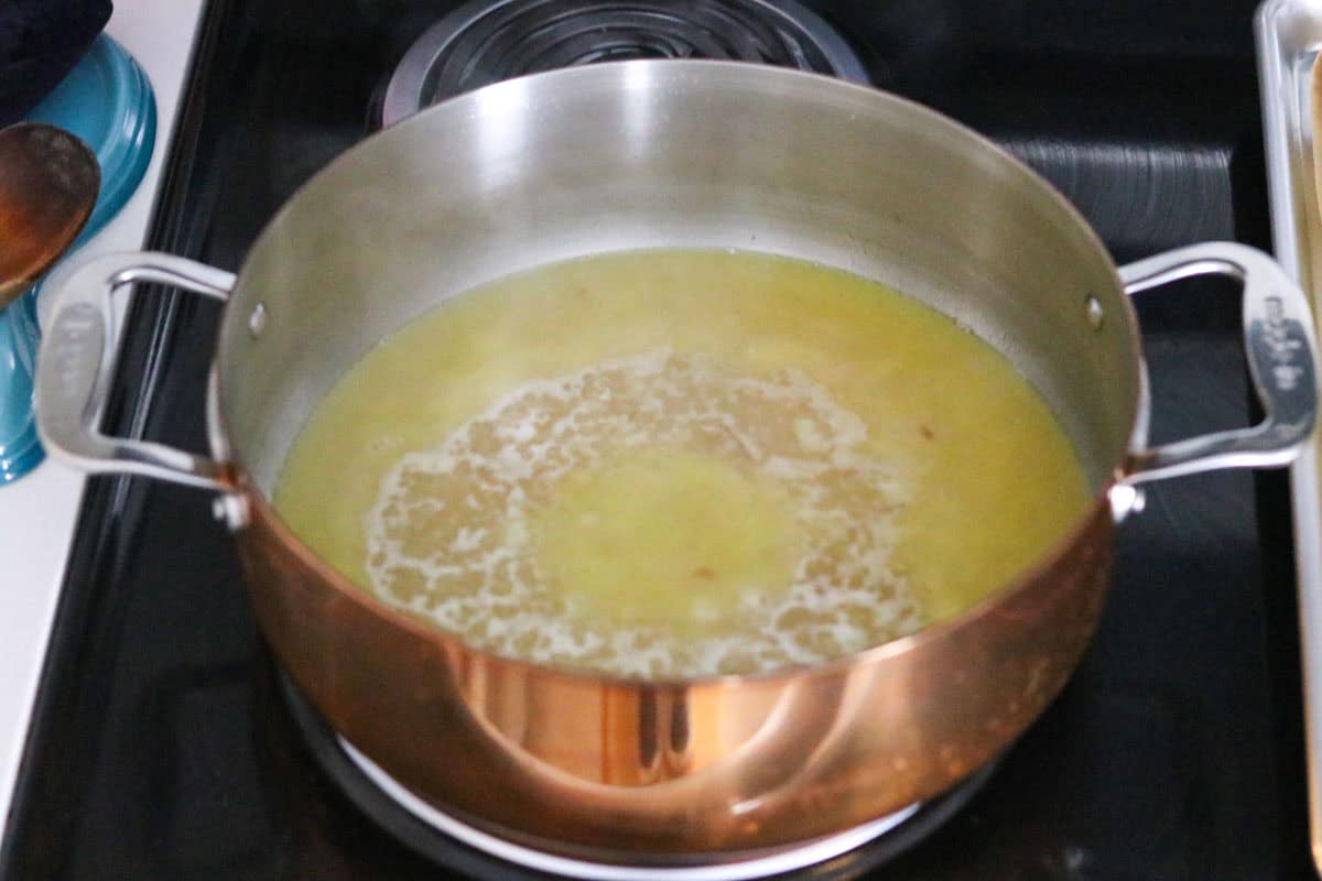 chicken broth and flour in a copper rondeau